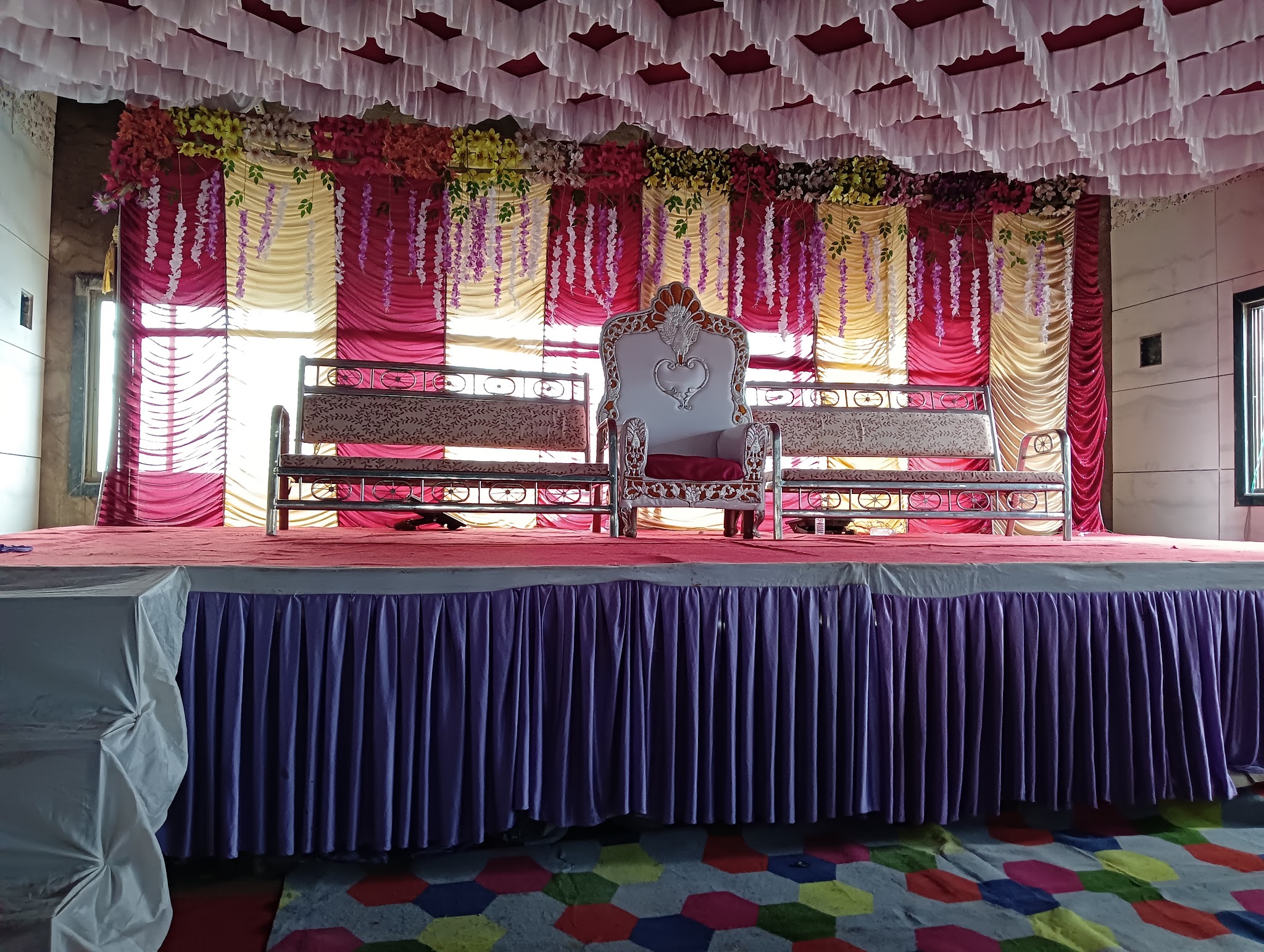 Draped stage set for an event inside the hall.
